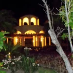 Nighttime garden view of lit structure