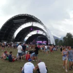 Outdoor music festival with large stage canopy