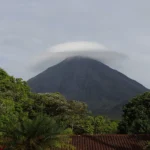 Volcano with cloud hat and green forest