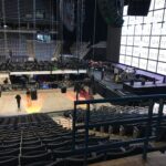 Empty indoor arena with stage setup and seating.