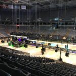 Large indoor arena with stage setup and lighting rigs.