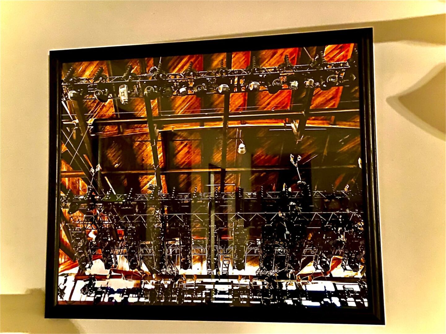 Decorative window grille with intricate patterns and autumn leaves outside.
