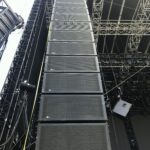 Tall line array speaker system set up on stage.