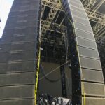 Large speaker arrays set up for a concert or event stage.