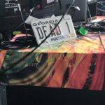 A Georgia DCAF license plate displayed on a colorful table.