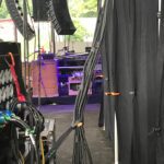 Behind-the-scenes view of stage cable management and equipment setup.