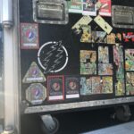 A truck back covered in colorful, artistic stickers and decals.