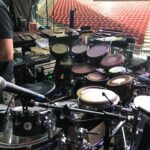 A large electronic drum kit set up on stage for a live performance.