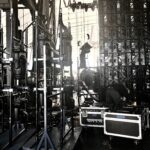 A person working backstage in a dimly lit concert or event setup.