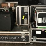 Stacked black and silver road cases for musical equipment storage.