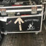 A large black equipment case with 'Mickey Hart' and a mouse graphic.