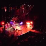 A vibrant live concert with colorful stage lights and performers.